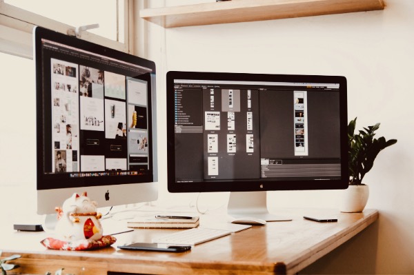 Dual display on wooden office desk